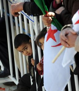 Algerian children look on as they attend President Abdelaziz Bouteflika's