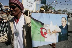 A supporter holds a poster of Algeria's President Abdelaziz Bouteflika