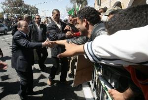 Algeria's President Abdelaziz Bouteflika (L) shakes hands with supporters as