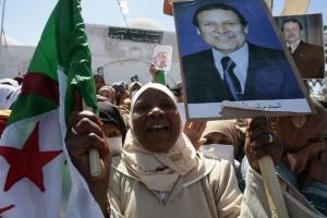 A supporter, holding a poster of Algeria's President Abdelaziz Bouteflika