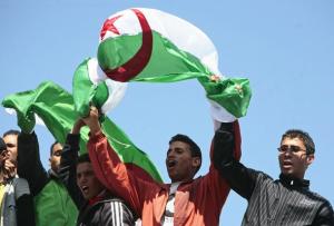 Supporters wave the Algerian flag as Algeria's President Abdelaziz Bouteflika