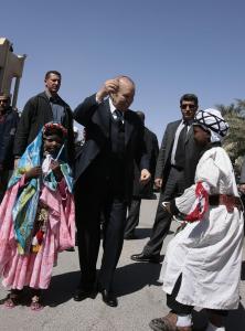 Algeria's President Abdelaziz Bouteflika (C) dances with children wearing traditional