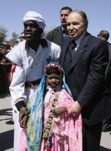 Algeria's President Abdelaziz Bouteflika (R) poses with people dressed in