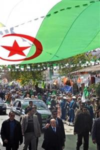 Algerian President Abdelaziz Bouteflika, foreground center, walks under an Algerian