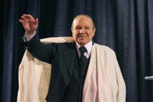 Algerian President Abdelaziz Bouteflika salutes the crowd while dressed in
