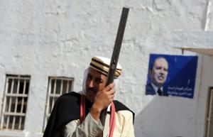 An Algerian horseman stands with President Abdelaziz Bouteflika's poster behind