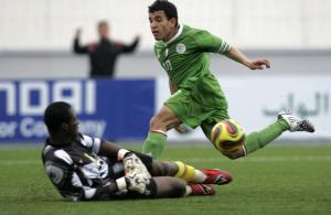 Algeria's Abdelhakim Bezaz (R) tries to score past Burkina Faso's