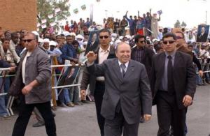 Algeria's President Abdelaziz Bouteflika, center, salutes crowds as he campaigns