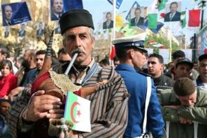 A musician plays his traditional Kabyle bagpipe as Algerian President