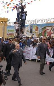 Algerians  welcome Algeria's President Abdelaziz Bouteflika who is campaigning