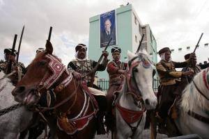 Horse riders in traditional robes watch Algeria's President and candidate
