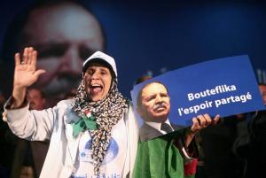 A woman greets Algeria's President and candidate in the forthcoming