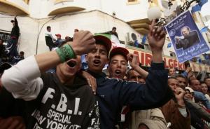 Supporters of Algeria's President Abdelaziz Bouteflika chant slogans during his