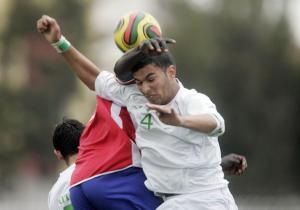 Algeria's Cherchar Mohamed Ilyas (R) fights for the ball with