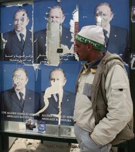 A man walks past posters of Abdelaziz Bouteflika, Algeria's President