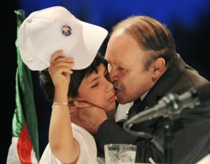Algerian President Abdelaziz Bouteflika kisses a child during the last