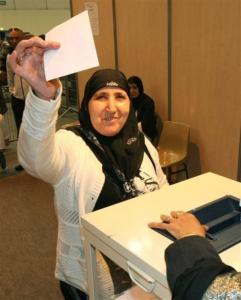An Algerian woman residing in France casts her ballot in