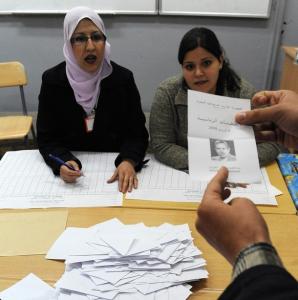 Algerians count ballots in a vote office in Algiers after