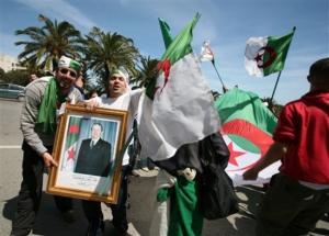Supporters of President Abdelaziz Bouteflika wave Algerian flags and hold