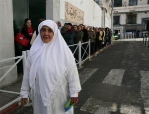 A woman walks past a voting center in the working