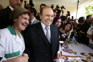 Algeria's President Abdelaziz Bouteflika smiles as he shakes hands with