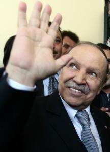 Algeria's President Abdelaziz Bouteflika waves to journalists at his campaign's