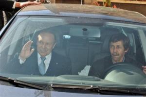 Algerian President Abdelaziz Bouteflika, left, waves as he arrives at