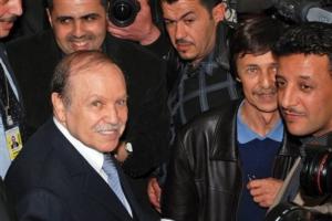 Algerian President Abdelaziz Bouteflika, foreground, arrives at his campaign headquarters