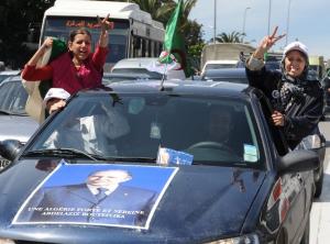 Algerians women flash the V for victory to celebrate along