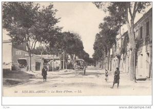 CPA  ALGERIE  SIDI BEL ABBES  Route d' ORAN Animée Maisons Attelage