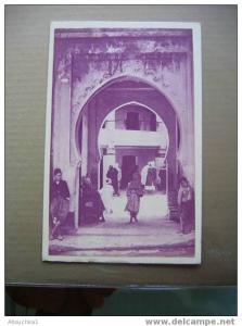 ALGERIE   EX COLONIE FRANCAISE   CENTENAIRE EN 1930 TLEMCEN  ENTREE D´UN FONDOUK    ASSEZ ANIMEE   TERRE ACCUEILLANTE