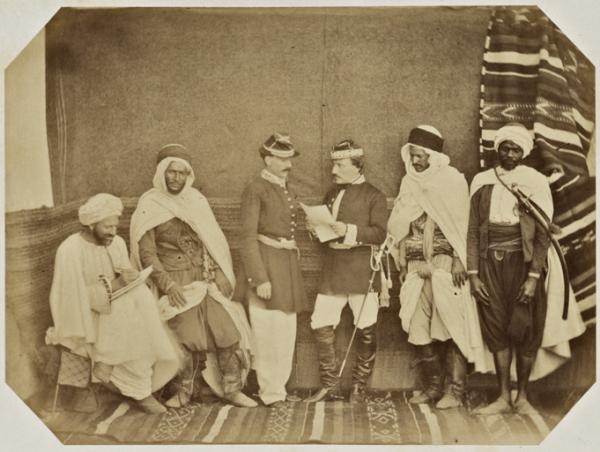 Bureau arabe départemental  d'Oran. [de gauche à droite]  Mohammed ben El Hadj Hassen Khodja (secrétaire) . Addour ben Khodra, Cheik des Hanaiane. M Mouin adjoint. M.Olivier, chef du bureau. Mustapha oued El Hadj Mustapha  Bey, cheik du village nègre. Sal (Photo rare)