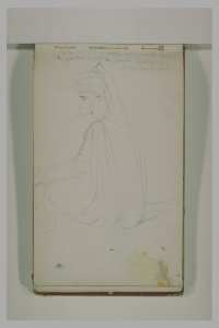 Un arabe, de profil, assis à terre, coiffé d'un turban