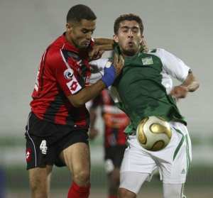 Firas Alkhateeb (R) of Kuwait's AlArabi fights for the