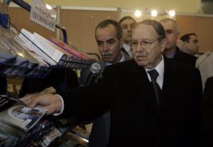 Algeria's President Abdelaziz Bouteflika looks at books during the
