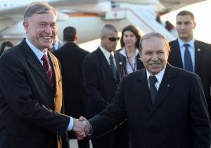 Algeria's President Abdelaziz Bouteflika (R) poses with his German