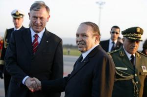Algeria's President Abdelaziz Bouteflika (R) shakes hands with his