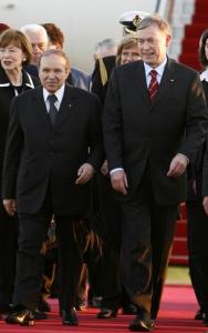 Algeria's President Abdelaziz Bouteflika (L) walks with his German