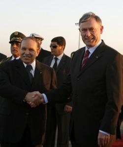 Algeria's President Abdelaziz Bouteflika (L) shakes hands with his