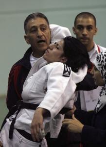 Kahana Saidi of Algeria (C) is held by her