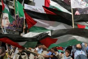 Palestinians participate in a rally to mark the 19th