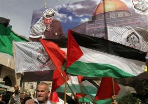 Beneath a poster showing the deceased Palestinian leader Yasser