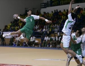 Saudi's Ali Abdulah (9) jumps in air to shoot