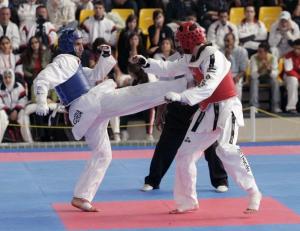 Algeria's Imran Hamoudi (blue) fights with Jordan's Tamer Kitwe