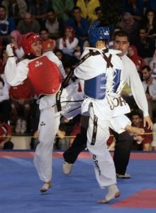 Jordan's Rima Annanbh (blue) fights with Algeria's Nasseri Shamam