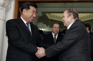 Algeria's President Abdelaziz Bouteflika (R) shakes hands with Chinese