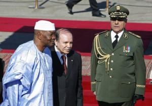 Algeria's President Abdelaziz Bouteflika (C) inspect honour guard with