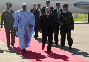Algeria's President Abdelaziz Bouteflika (R) escorts his Malian counterpart
