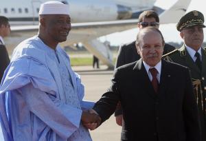 Algerian President Abdelaziz Bouteflika (R) shakes hand with his