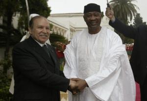 Algeria's President Abdelaziz Bouteflika (L) shakes hands with his